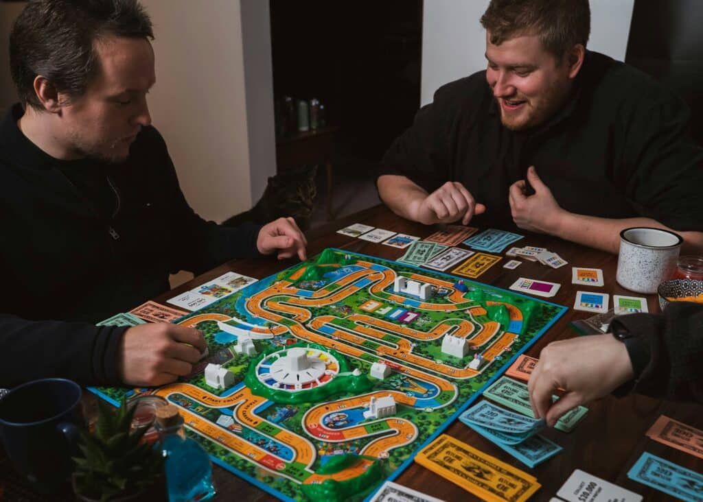 Two people playing a board game at a table